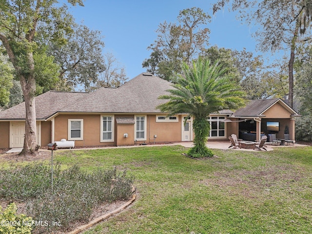 rear view of property featuring a yard and a patio area