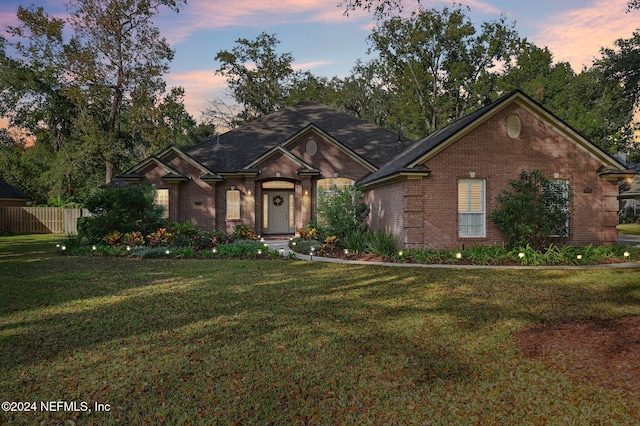 ranch-style house with a yard