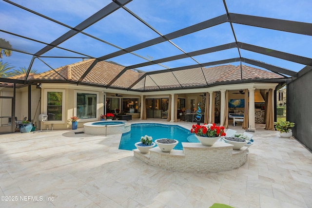 view of pool with an in ground hot tub, a patio area, ceiling fan, and a lanai