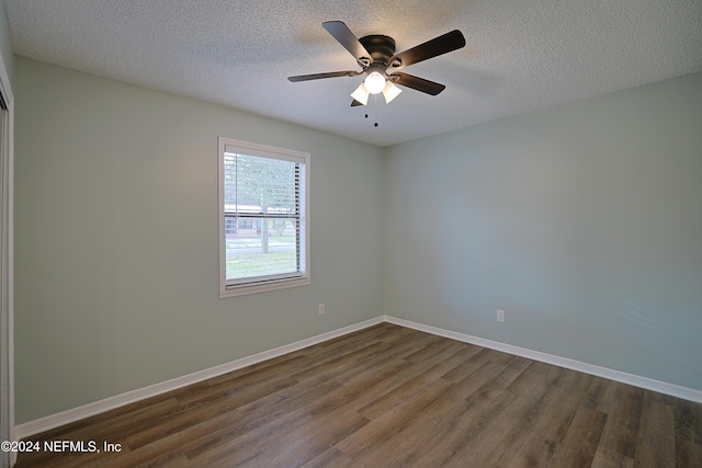 unfurnished room with dark hardwood / wood-style floors, ceiling fan, and a textured ceiling