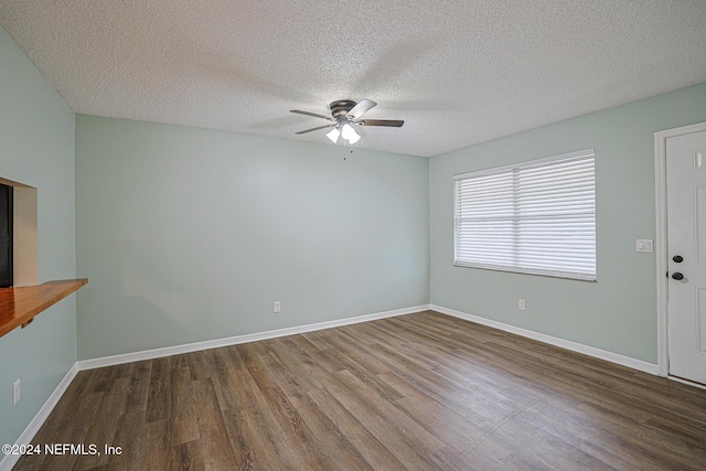 empty room featuring a textured ceiling, hardwood / wood-style flooring, and ceiling fan