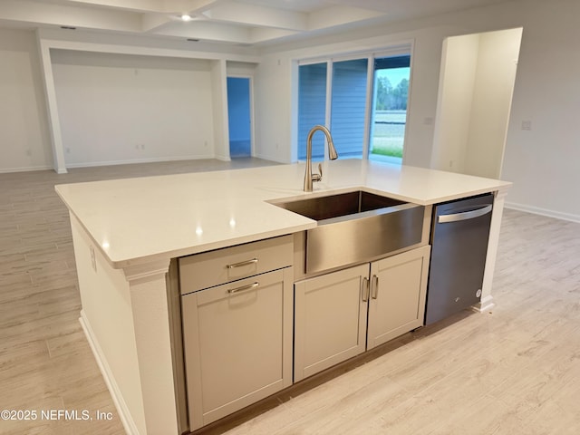 kitchen featuring stainless steel dishwasher, light wood-style floors, open floor plan, and a sink