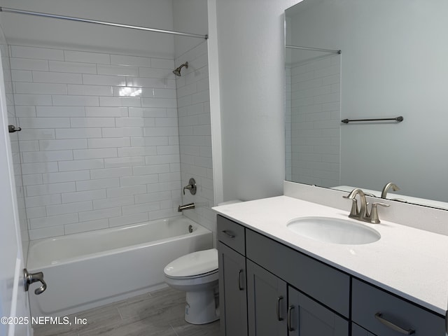 bathroom with vanity, toilet, bathing tub / shower combination, and wood finished floors