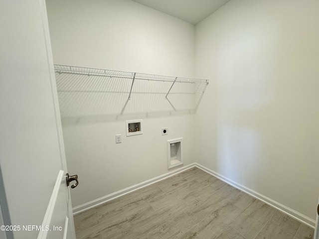 laundry area featuring electric dryer hookup, wood finished floors, baseboards, hookup for a washing machine, and laundry area