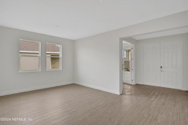 unfurnished room with light hardwood / wood-style flooring