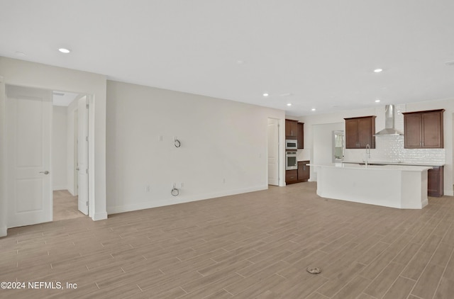 unfurnished living room featuring sink