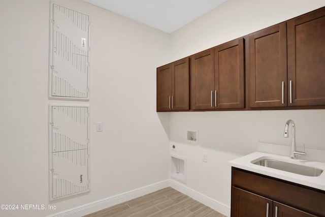 washroom with cabinets, electric dryer hookup, sink, and washer hookup