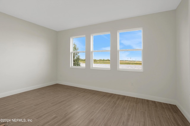 spare room with hardwood / wood-style floors