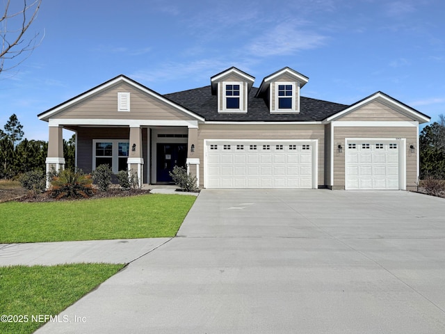 view of front facade with a garage, a porch, and a front lawn