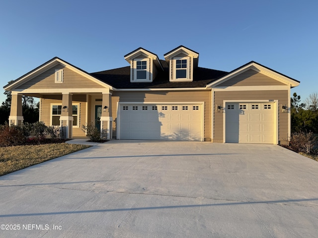 view of front of house with concrete driveway and an attached garage