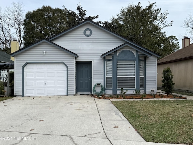 single story home featuring a front yard and a garage