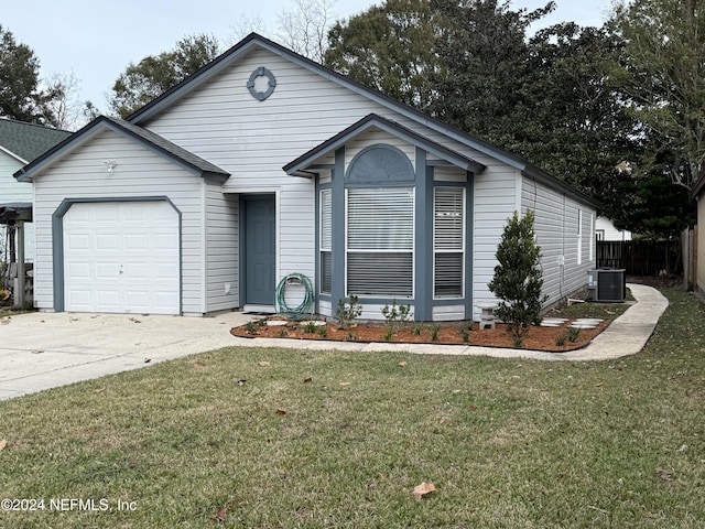 view of front of home featuring a front lawn, central AC unit, and a garage