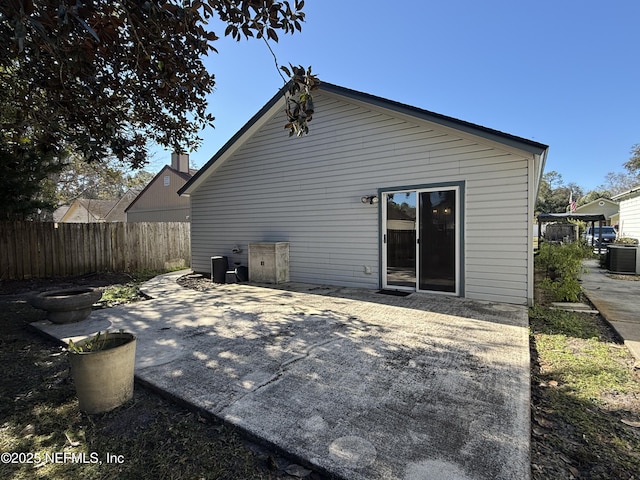 rear view of property featuring central AC and a patio area