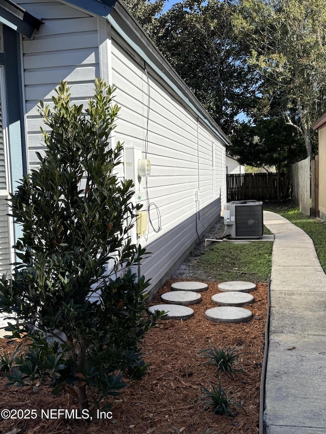 view of side of property featuring central air condition unit