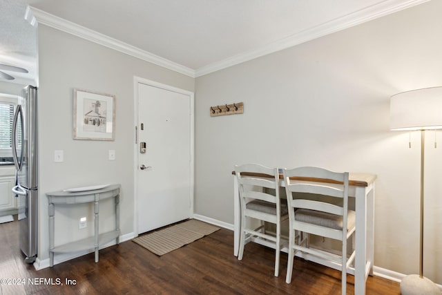 foyer featuring dark hardwood / wood-style flooring and crown molding