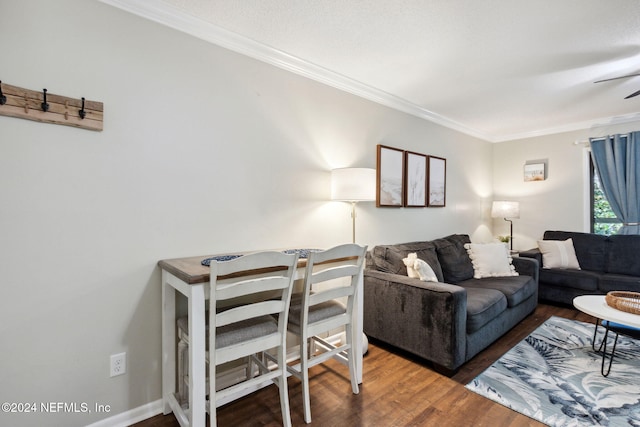 living room with ceiling fan, wood-type flooring, and ornamental molding