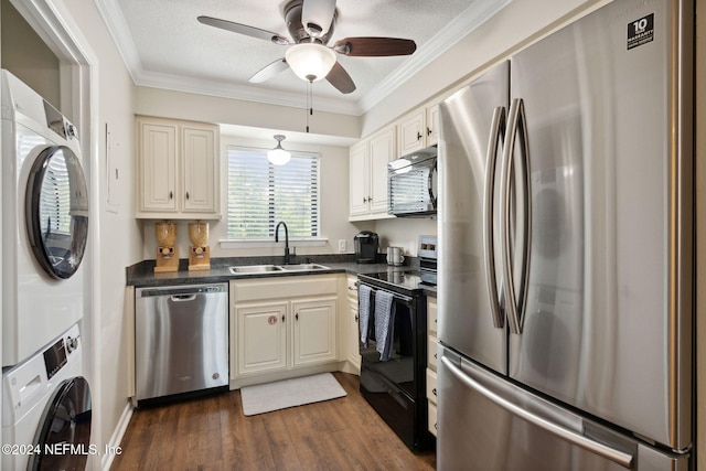 kitchen with ornamental molding, sink, black appliances, stacked washer / dryer, and dark hardwood / wood-style floors