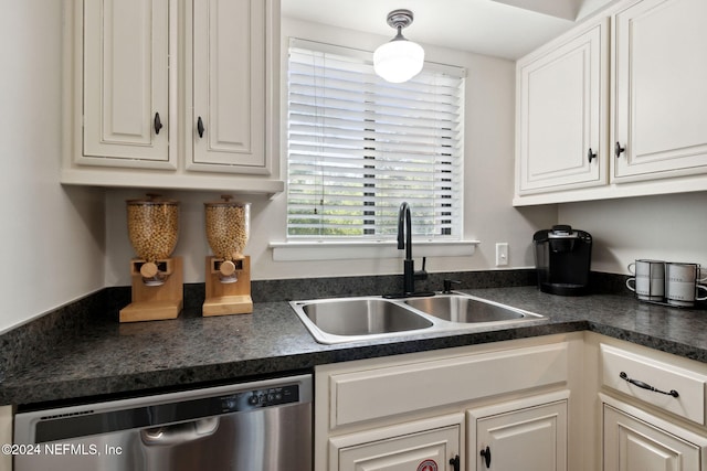 kitchen featuring white cabinetry, dishwasher, decorative light fixtures, and sink