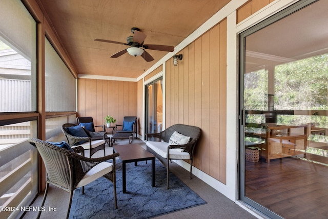 sunroom / solarium with ceiling fan and wood ceiling