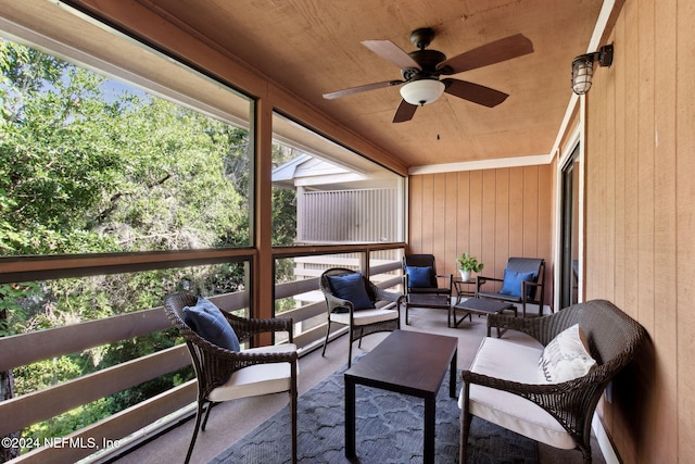 sunroom / solarium featuring ceiling fan and wood ceiling