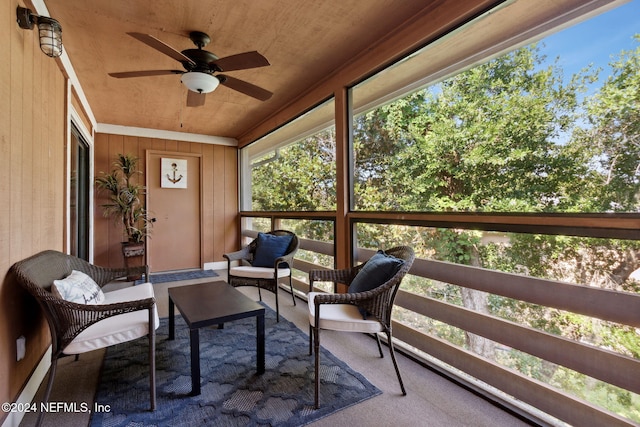 sunroom / solarium with ceiling fan and wooden ceiling