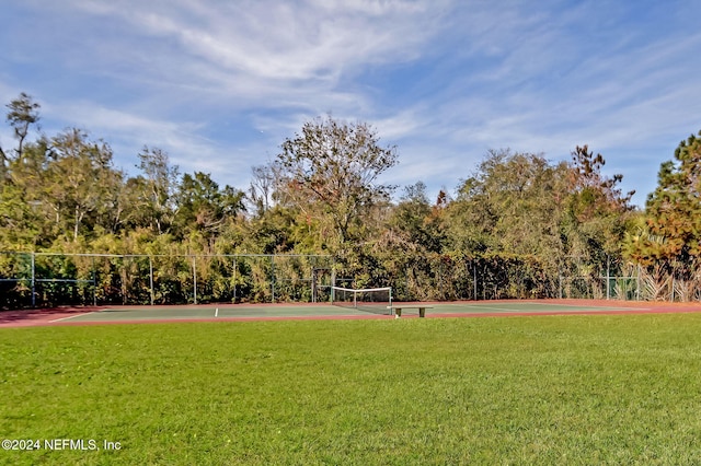 surrounding community with volleyball court and a yard