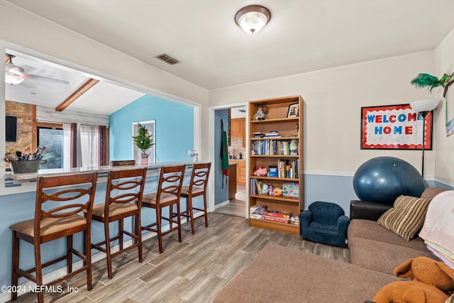 interior space featuring ceiling fan, lofted ceiling, and hardwood / wood-style flooring