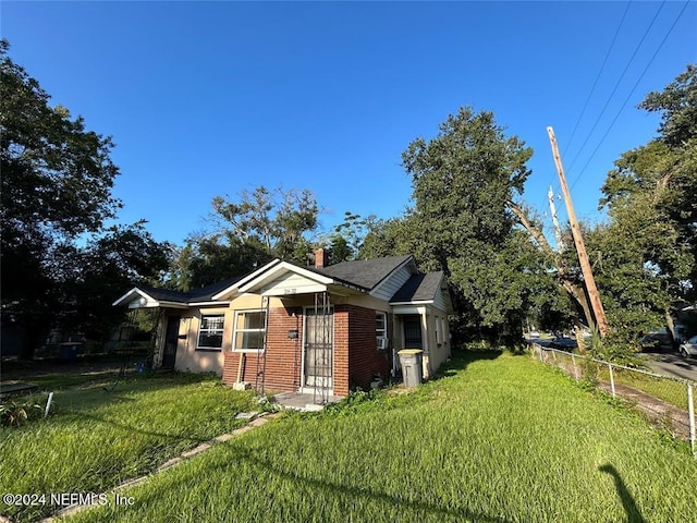 view of side of home featuring a yard