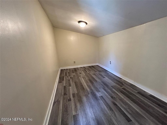 empty room featuring dark hardwood / wood-style flooring