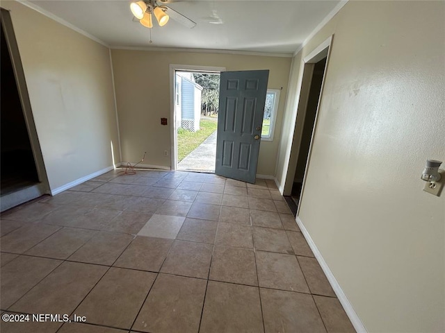 foyer with light tile patterned floors, ceiling fan, and crown molding