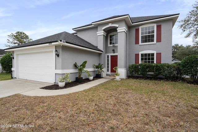 view of front of house with a front lawn and a garage