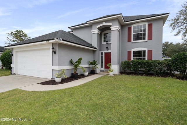 view of front facade with a garage and a front lawn