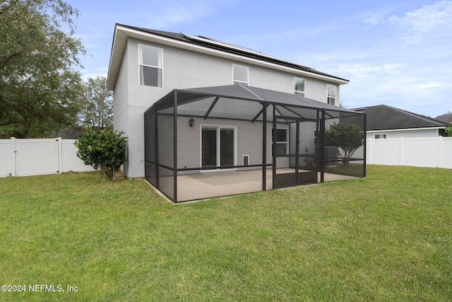 back of house featuring a lanai, a yard, and a patio