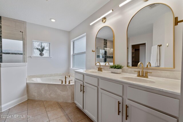 bathroom with separate shower and tub, tile patterned flooring, and vanity