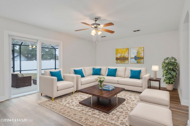 living room with ceiling fan and hardwood / wood-style floors