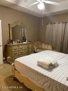 bedroom with ceiling fan and carpet floors