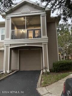 view of front of house with a garage and a balcony