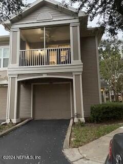 view of home's exterior featuring a balcony and a garage