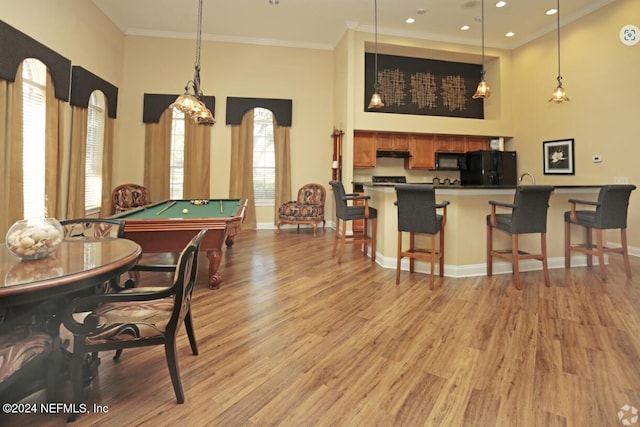 recreation room with light hardwood / wood-style floors, ornamental molding, and pool table