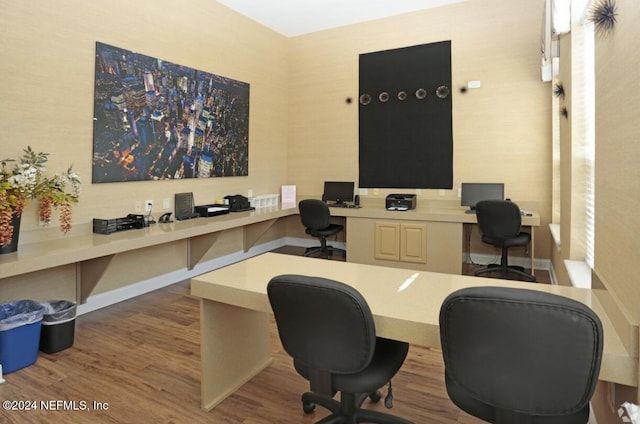 office area with light hardwood / wood-style floors and built in desk