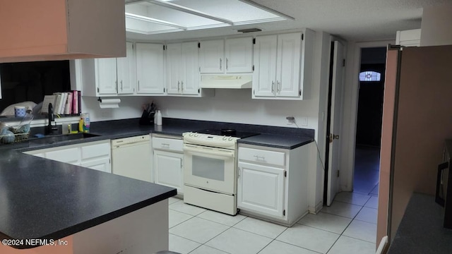 kitchen featuring white cabinetry, sink, light tile patterned floors, and white appliances