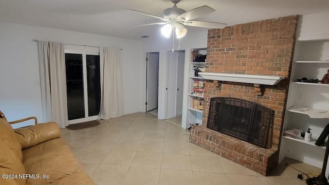 tiled living room featuring ceiling fan, built in features, a textured ceiling, and a brick fireplace