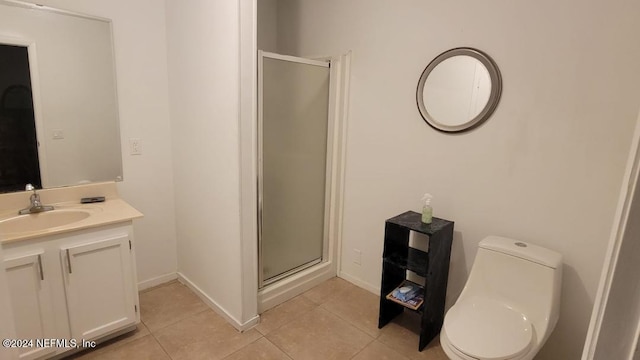 bathroom featuring toilet, vanity, tile patterned floors, and walk in shower