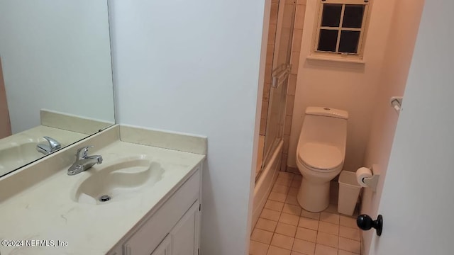 full bathroom featuring tile patterned flooring, vanity, bath / shower combo with glass door, and toilet