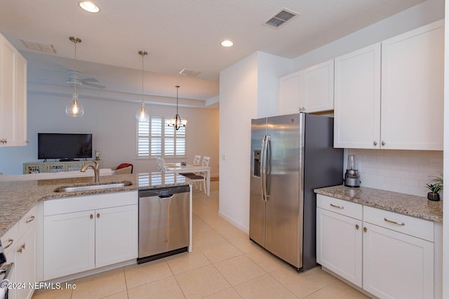 kitchen with white cabinets, hanging light fixtures, sink, and appliances with stainless steel finishes