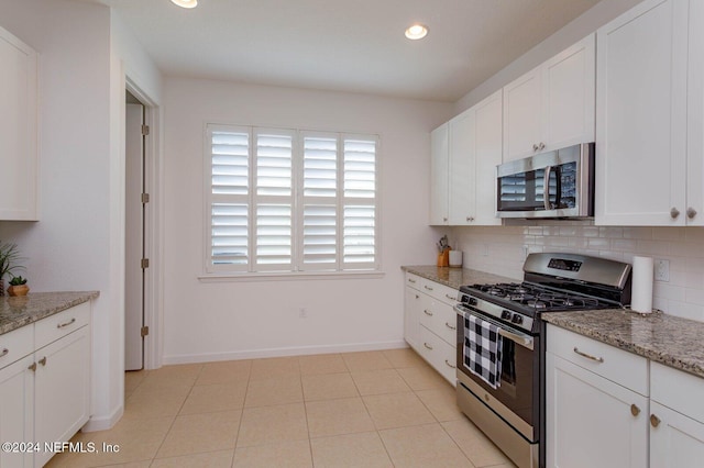 kitchen featuring light stone countertops, white cabinetry, and stainless steel appliances