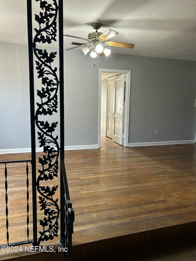 spare room with dark hardwood / wood-style floors and ceiling fan