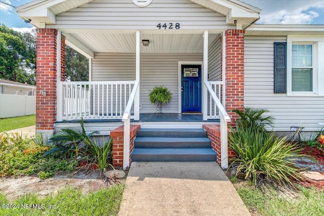 doorway to property featuring covered porch