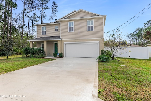 view of property featuring a front yard and a garage