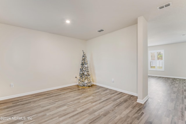 unfurnished room with light hardwood / wood-style floors